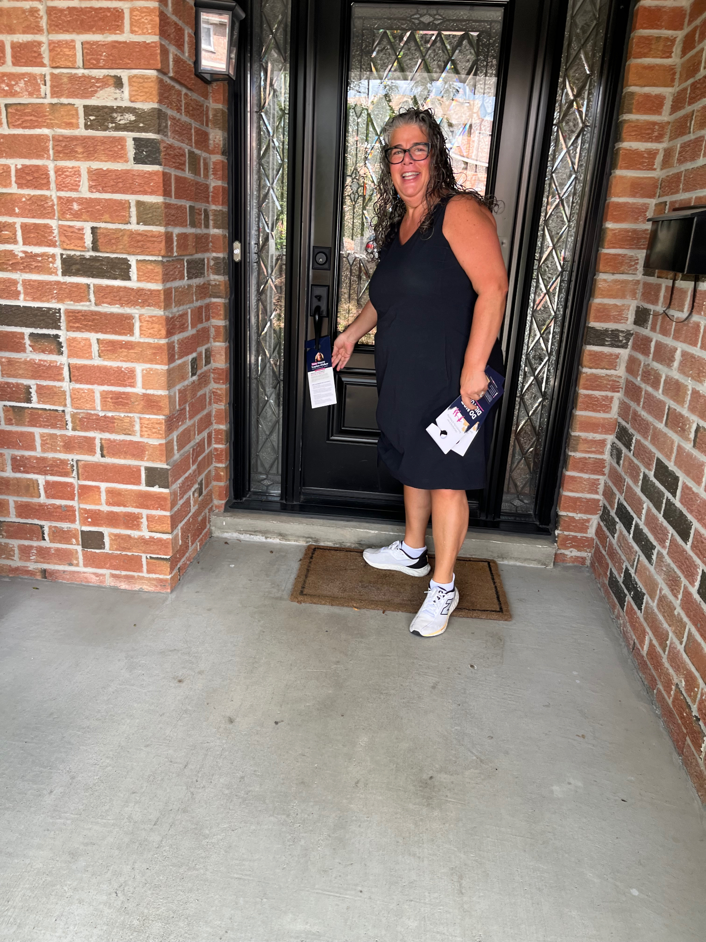 Stacey Lepine-Fisher canvassing in Ward 2, speaking with residents at their front door.